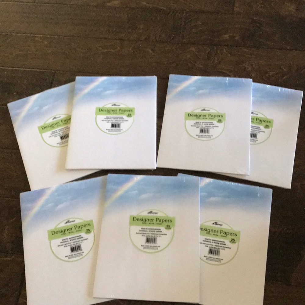 Unopened. 7 Packs-25 count Letter size paper w/ rainbow design